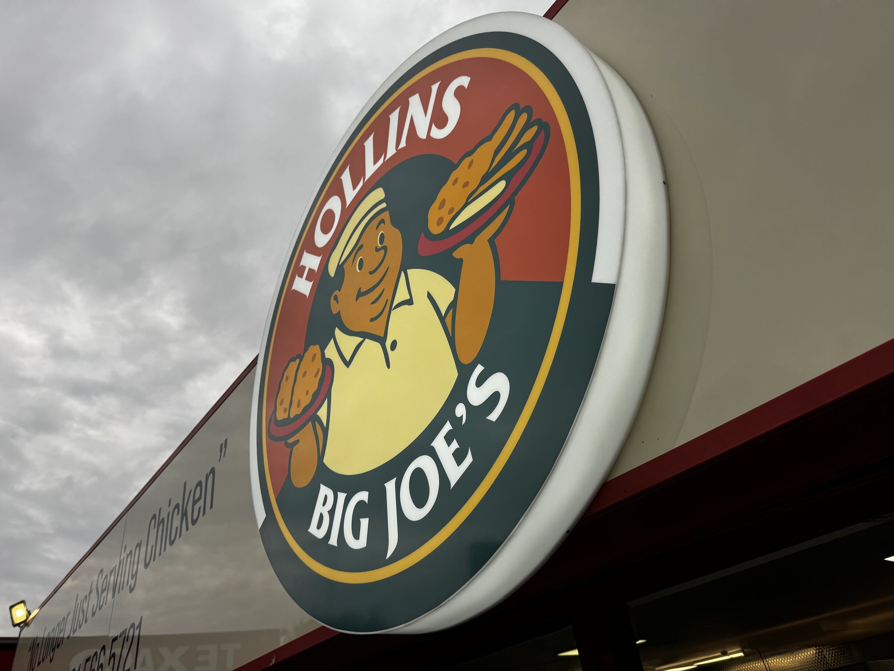 Collins Big Joe illuminated round projecting sign
