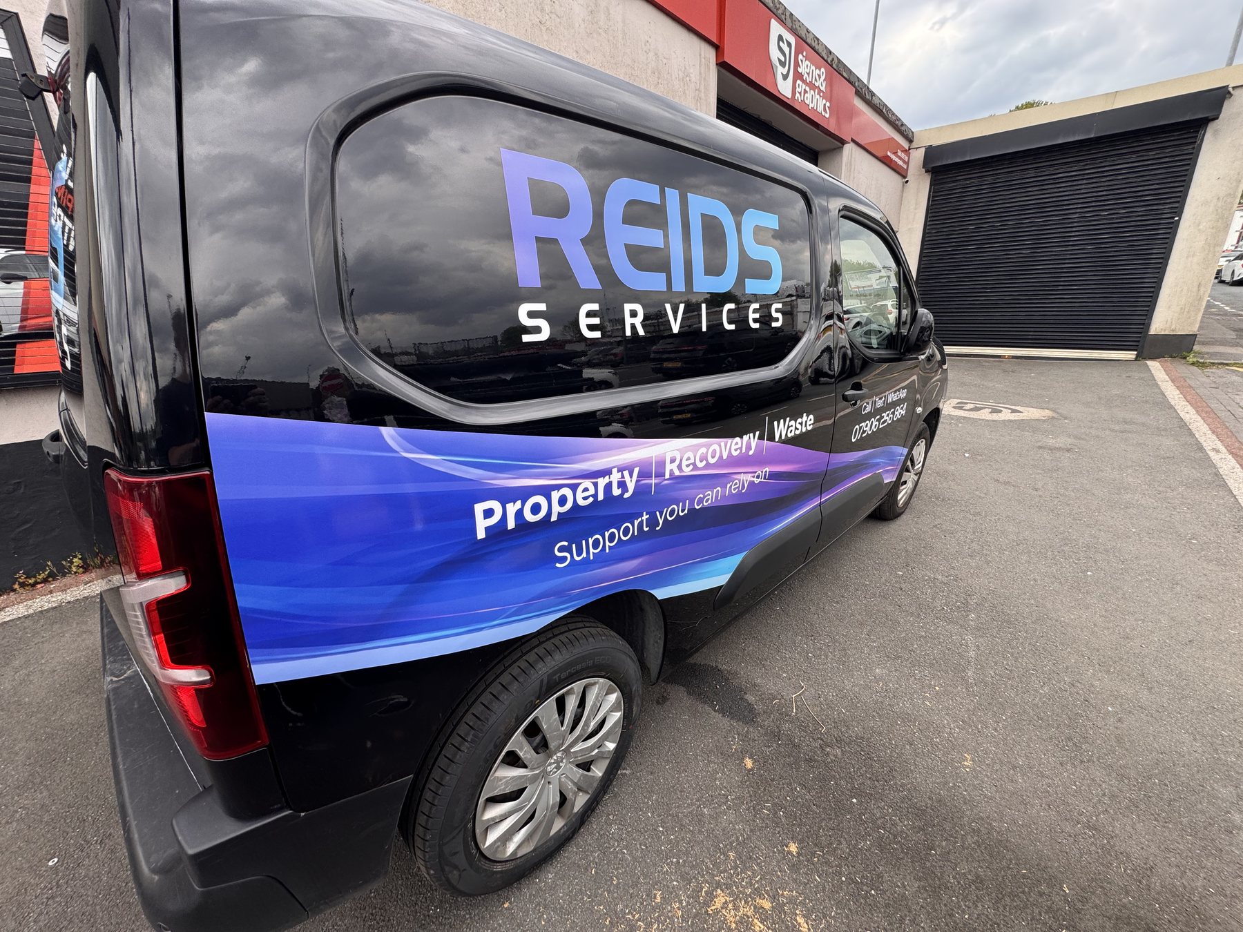 Reids Services black and blue van wrap